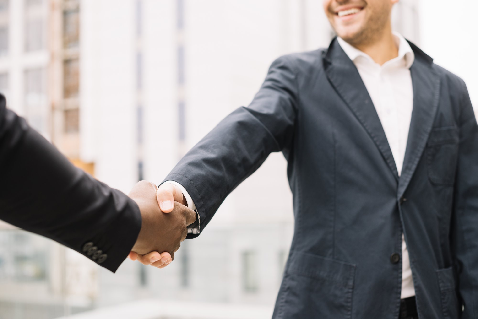 smiling-man-shaking-hand-colleague
